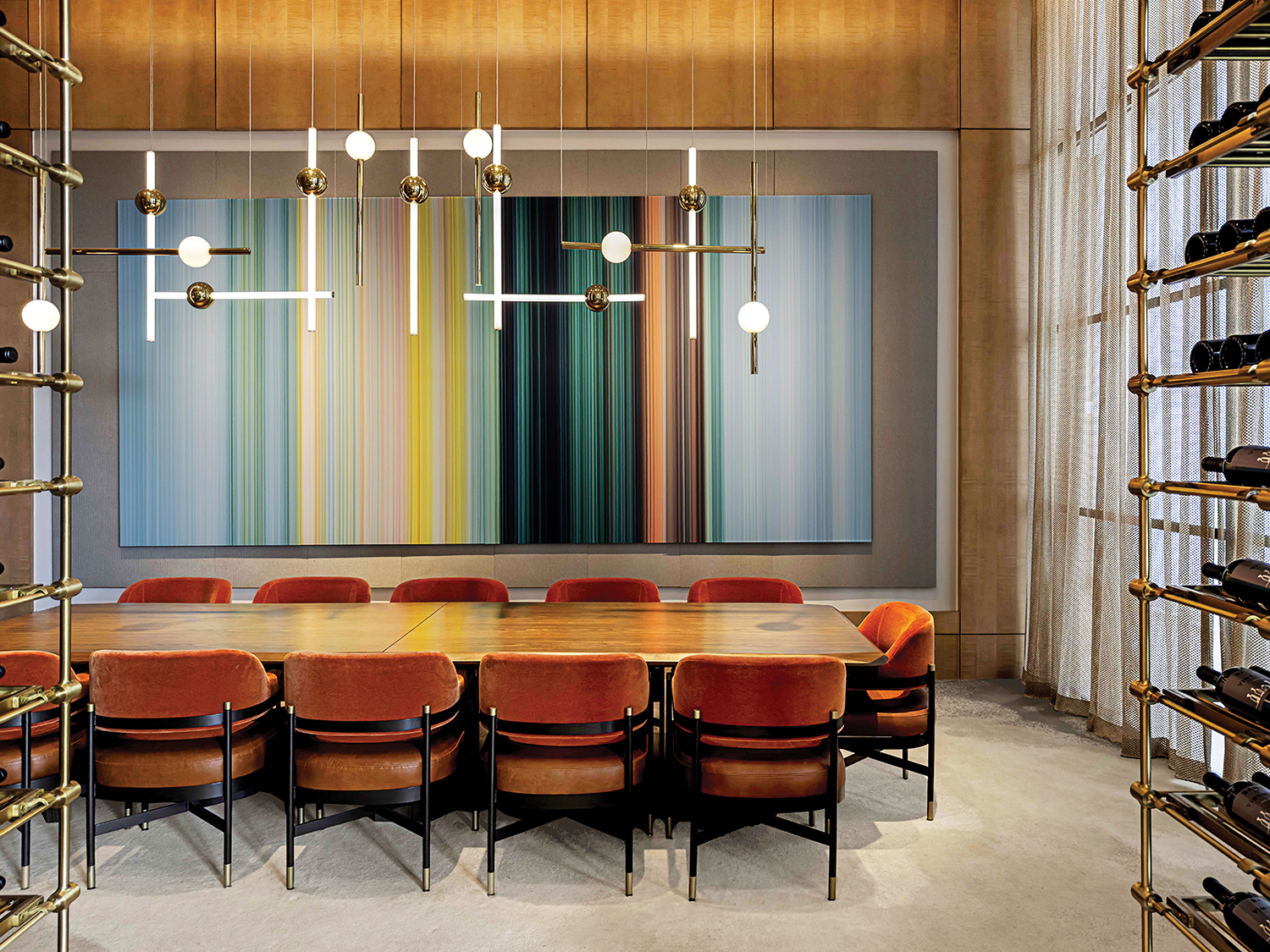 A room with a table and chairs and a large painting