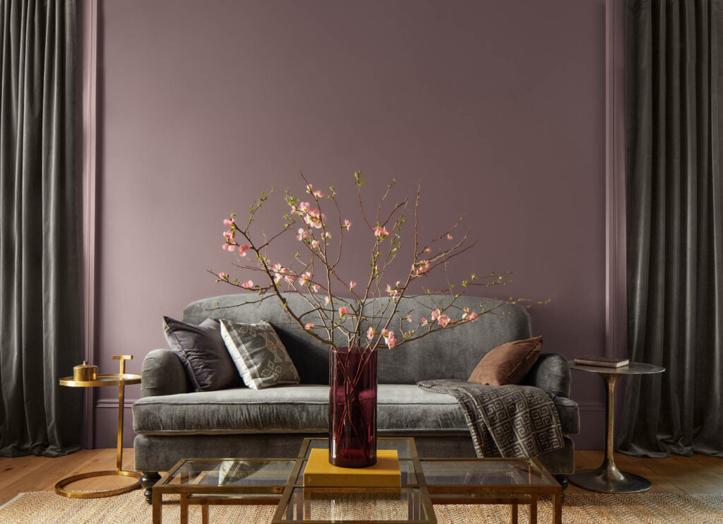 Benjamin Moore Color of the Year 2025 Cinnamon Slate paint on walls behind teal couch and flowers